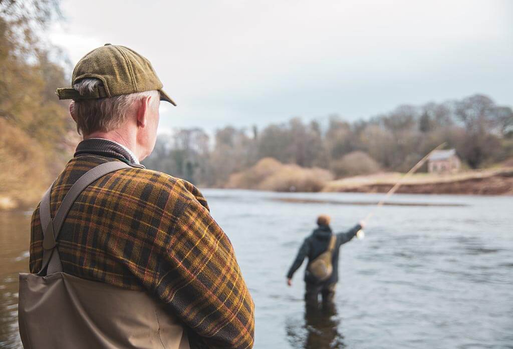 Kev the hat, ghillie at Milne Graden watching over the fisherman on the tweed